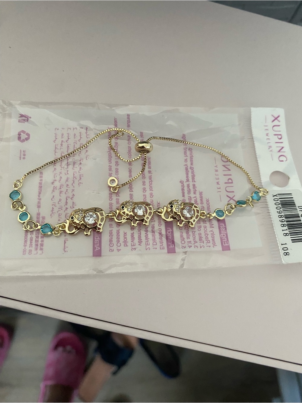 Ping Gold-Tone Bracelet with Blue Stones and Elephant Motifs